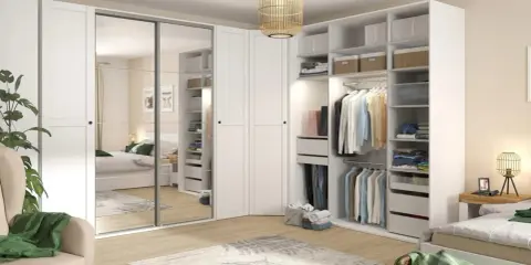 Zorganizowana garderoba w stylu Marie Kondo: białe fronty, lustrzane drzwi, półki z pudełkami i wieszaki z ubraniami.